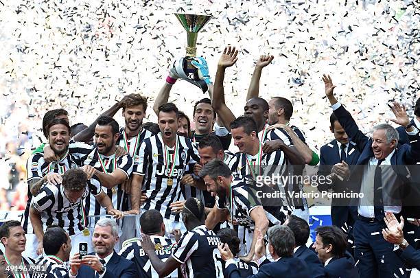 The Juventus FC players celebrate with the Serie A trophy at the end of the Serie A match between Juventus and Cagliari Calcio at Juventus Arena on...