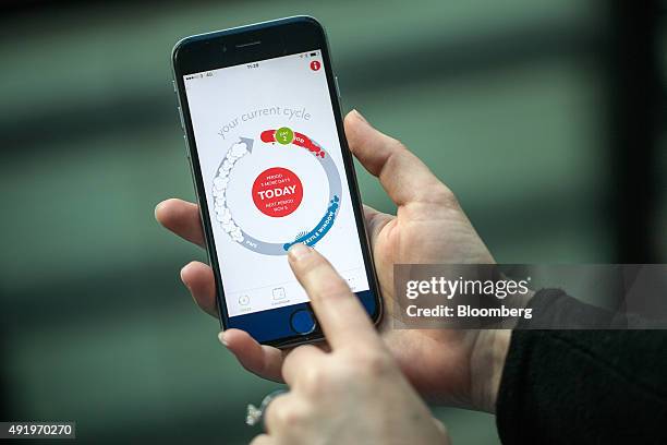 Finger points to a screen of the Clue health app, made by BioWink GmbH, on a smart device in this arranged photograph in London, U.K., on Friday,...