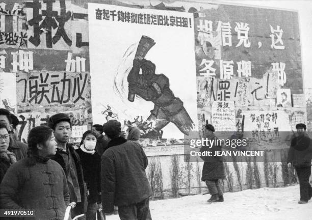 Small group of Chinese youths walk past several dazibaos, the revolutionary placards, in February 1967 in downtown Beijing, during the "Great...
