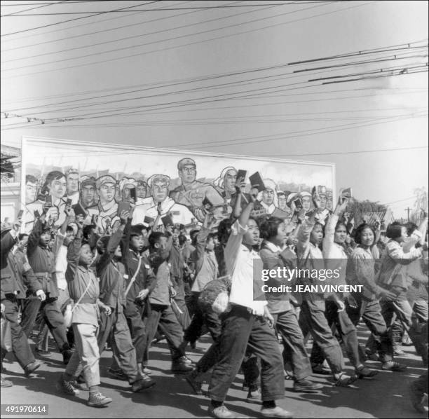 Red Guards, high school and university students, waving copies of Chairman Mao Zedong's "Little Red Book," parade in June 1966 in Beijing's streets...