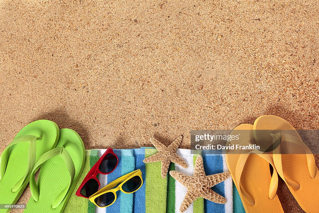 Beach background with sunglasses and flip flops