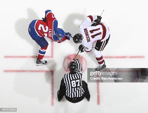 Jason Dickinson of the Guelph Storm takes a faceoff against Curtis Lazar of the Edmonton Oil Kings in Game Two of the 2014 Mastercard Memorial Cup at...