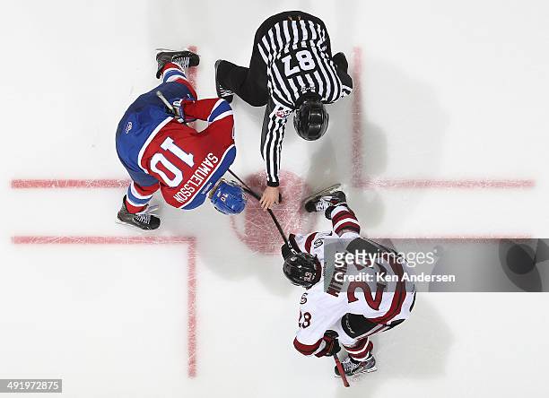 Zack Mitchell of the Guelph Storm takes a faceoff against Henrik Samuelsson of the Edmonton Oil Kings in Game Two of the 2014 Mastercard Memorial Cup...