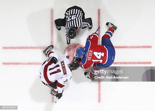 Jason Dickinson of the Guelph Storm takes a faceoff against Riley Kieser of the Edmonton Oil Kings in Game Two of the 2014 Mastercard Memorial Cup at...