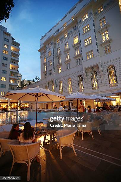 People gather near the pool at the famed Copacabana Palace hotel on May 17, 2014 in Rio de Janeiro, Brazil. The famed hotel was inaugurated in 1923...