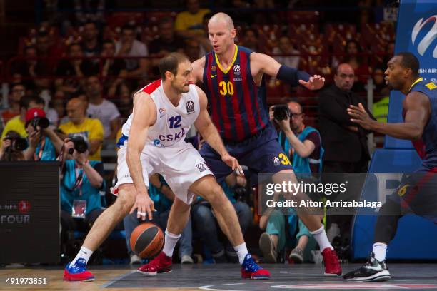 Nenad Krstic, #12 of CSKA Moscow competes with Maciej Lampe, #30 of FC Barcelona during the Turkish Airlines EuroLeague Final Four third place game...