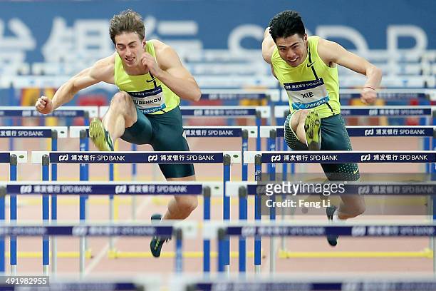 Chinese hurdler Xie Wenjun competes against Russia's Sergey Shubenjov during the men's 110-meter hurdles of the Diamond League Track and Field...