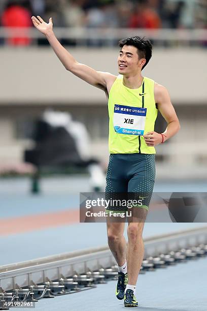 Chinese hurdler Xie Wenjun celebrates after upsetting world champion David Olvier during the men's 110-meter hurdles of the Diamond League Track and...