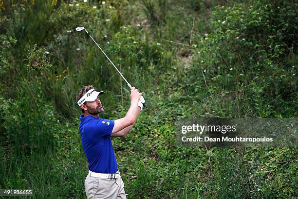 Raphael Jacquelin of France hits his second shot on the 1st hole during the final round of the Open de Espana held at PGA Catalunya Resort on May 18,...