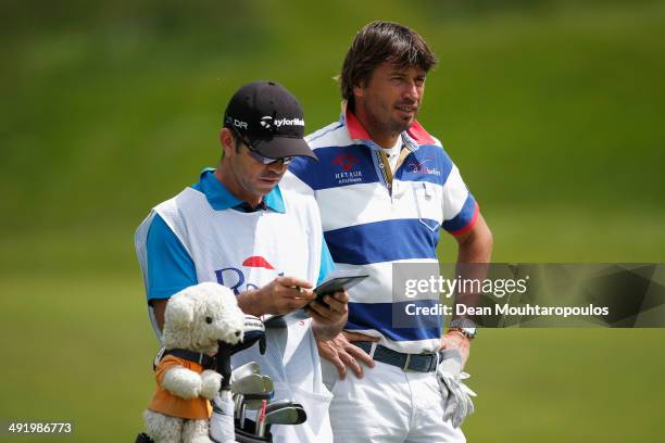 Robert-Jan Derksen of The Netherlands speaks to his caddie before he hits his second shot on the 1st hole during the final round of the Open de...