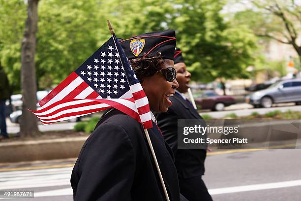 Veteran Brenda Ephriam marches with soldiers, boy scouts and various other military aligned groups in the 369th Infantry Regiment Parade in Harlem on...