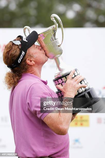 Miguel Angel Jimenez celebrates with the trophy after winning the Open de Espana held at PGA Catalunya Resort on May 18, 2014 in Girona, Spain.
