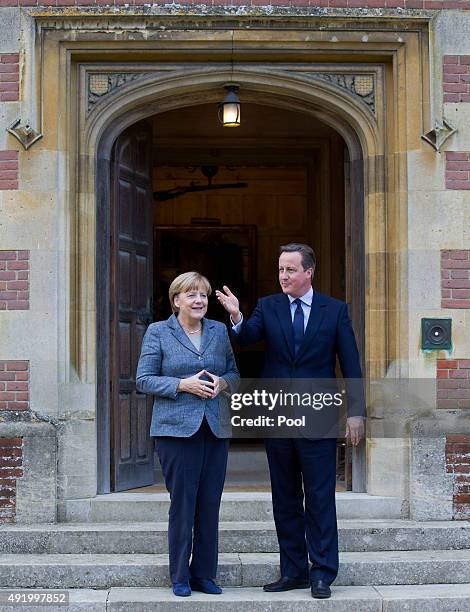 Prime Minister David Cameron greets German Chancellor Angela Merkel as he meets with her at Chequers, the Prime Minister's country residence on...