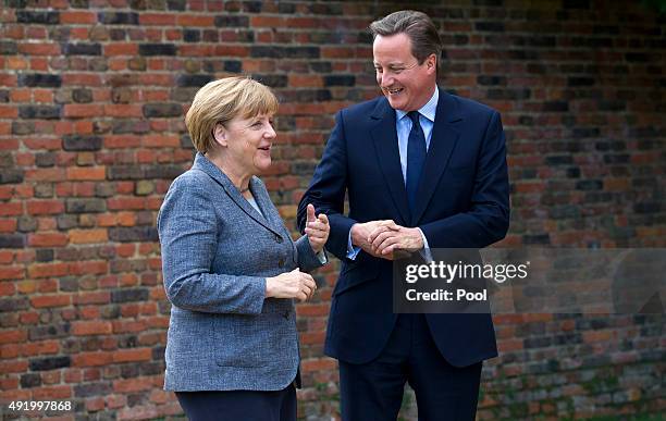 Prime Minister David Cameron greets German Chancellor Angela Merkel as he meets with her at Chequers, the Prime Minister's country residence on...
