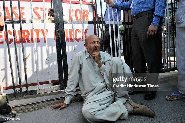 Independent Legislator Engineer Rashid sit outside Secretariat gate during a protest march on October 9, 2015 in Srinagar, India. Police detained...