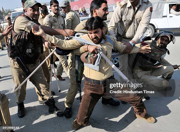 Supporter of Independent legislator Engineer Rashid detained by police during a protest march on October 9, 2015 in Srinagar, India. Police detained...