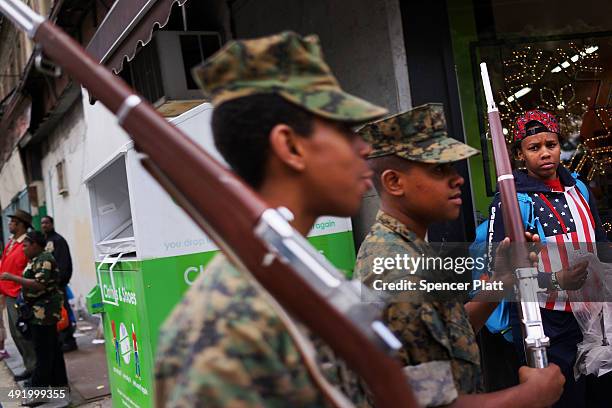Memebrs of the Harlem Youth Marines march with soldiers, Boy scouts, veterans and various other military aligned groups in the 369th Infantry...