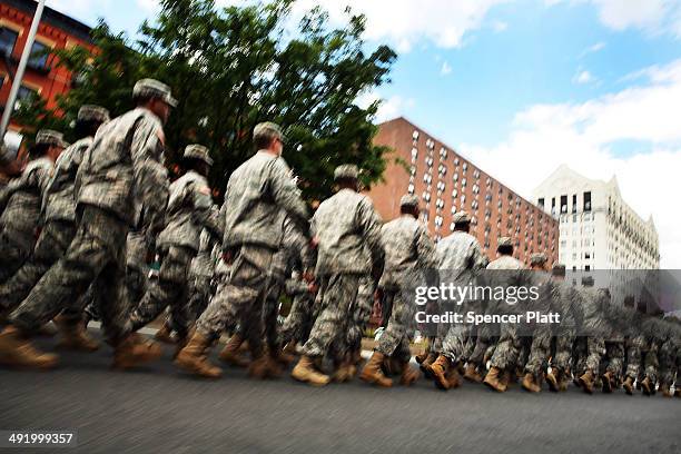 Memebrs of the Army's 369th Infantry Regiment march with fellow soldiers, Boy Scouts and various other military aligned groups in the 369th Infantry...