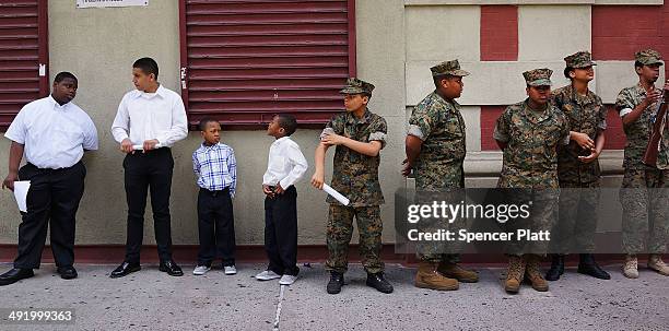 Memebrs of the Harlem Youth Marines prepare to march with soldiers, Boy Scouts, veterans and various other military aligned groups in the 369th...