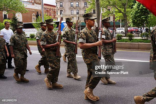 Memebrs of the Harlem Youth Marines march with soldiers, Boy scouts, veterans and various other military aligned groups in the 369th Infantry...