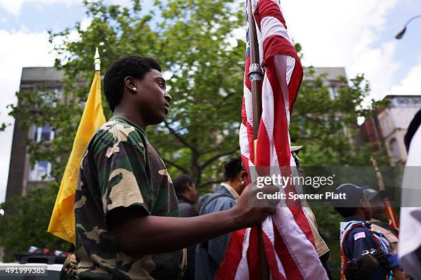 Teen marches with soldiers, veterans and various other military aligned groups in the 369th Infantry Regiment Parade in Harlem on May 18, 2014 in New...