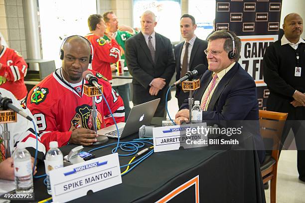 Chicago Blackhawks owner Rocky Wirtz talks on the radio with professional football player Jarrett Payton prior to Game One of the Western Conference...