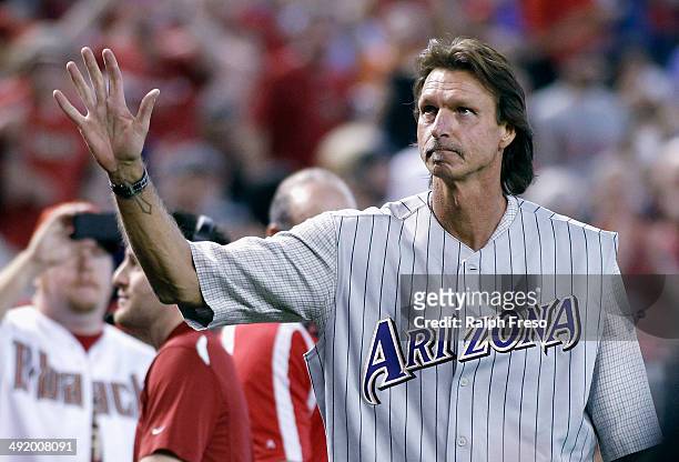 Former Arizona Diamondbacks pitcher Randy Johnson waves to fans during a ceremony celebrating the 10th anniversary of his perfect game before the...