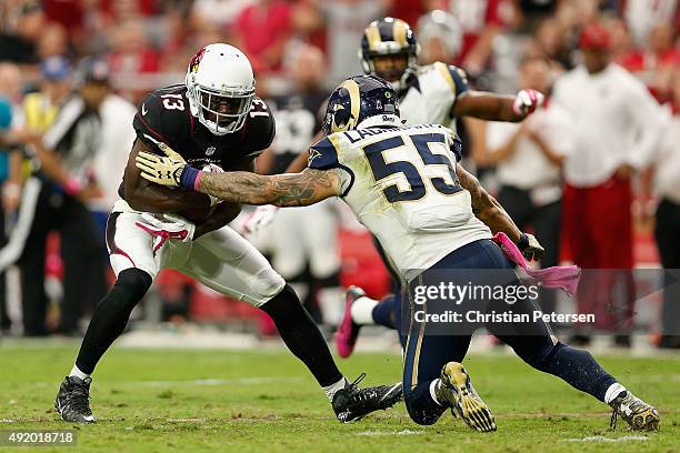 Wide receiver Jaron Brown of the Arizona Cardinals runs with the football after a reception against middle linebacker James Laurinaitis of the St....