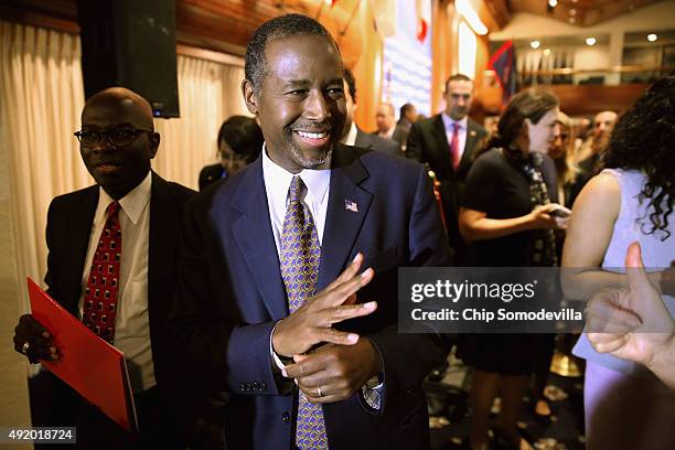 Republican presidential candidate Dr. Ben Carson waves to supporters after addressing the National Press Club Newsmakers Luncheon October 9, 2015 in...