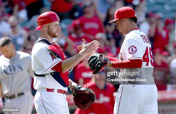 Relief pitcher Ernesto Frieri and catcher Chris Iannetta of the Los Angeles Angels of Anaheim shake hands after getting the final out against the...