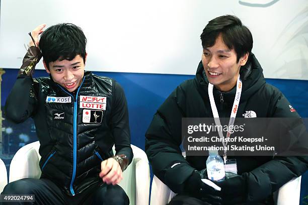 Daichi Miyata of Japan and his coach Naoki Shigematsu smile after the presentation of the junior men free skating of the ISU Junior Grand Prix at Dom...