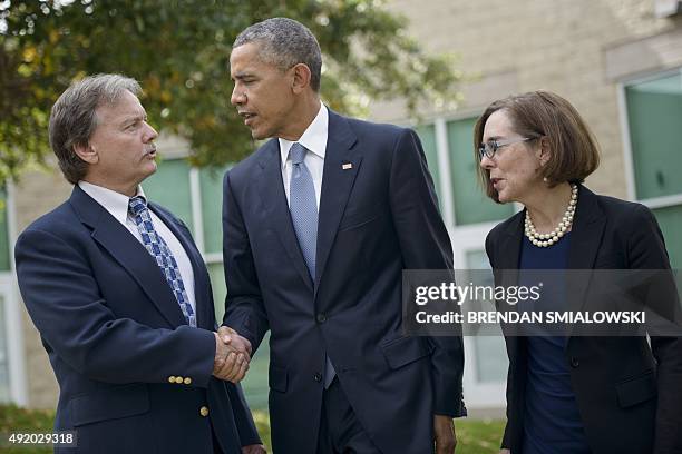 Oregon Governor Kate Brown watches as US President Barack Obama shakes hands with Roseburg Mayor Larry Rich after meeting with the families of the...