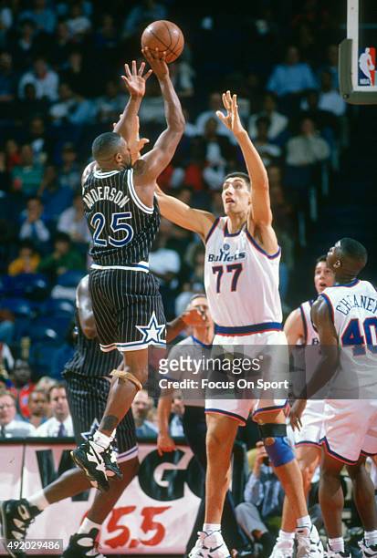 Nick Anderson of the Orlando Magic shoots over Gheorghe Muresan of the Washington Bullets during an NBA basketball game circa 1993 at the Capital...