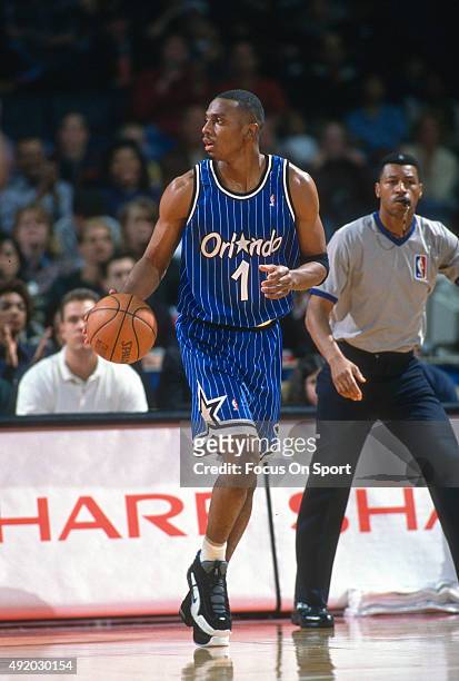 Penny Hardaway of the Orlando Magic dribbles the ball against the Washington Bullets during an NBA basketball game circa 1997 at US Airways Arena in...
