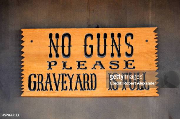 Sign at the entrance to the legendary Boothill Graveyard in Tombstone, Arizona, informs visitors that guns are not allowed. The historic 19th century...
