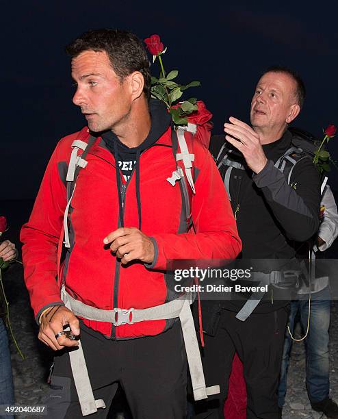 Former Societe General trader Jerome Kerviel, assisted by priest Patrice Gourrier , surrenders to police at the French border on May 18, 2014 in...