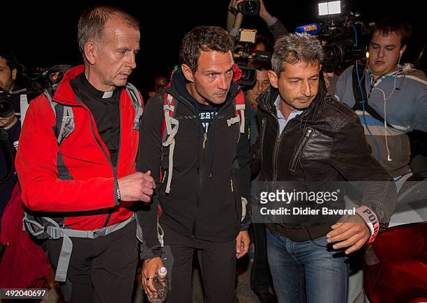 Former Societe General trader Jerome Kerviel, assisted by priest Patrice Gourrier , surrenders to police at the French border on May 18, 2014 in...