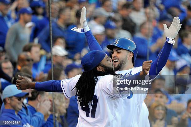 Eric Hosmer of the Kansas City Royals celebrates with Johnny Cueto after scoring off of Josh Fields of the Houston Astros walking Salvador Perez of...