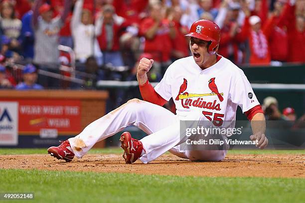 Stephen Piscotty of the St. Louis Cardinals celebrates scoring a run in the first inning against the Chicago Cubs during game one of the National...