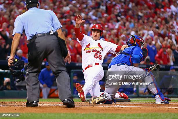 Stephen Piscotty of the St. Louis Cardinals scores a run in the first inning against the Chicago Cubs during game one of the National League Division...