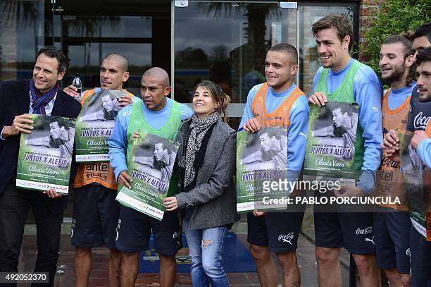 Uruguay's players pose with friends of Uruguayan goalkeeper Alexis Viera who recovers from gunshot wounds received in Colombia, to promote a charity...