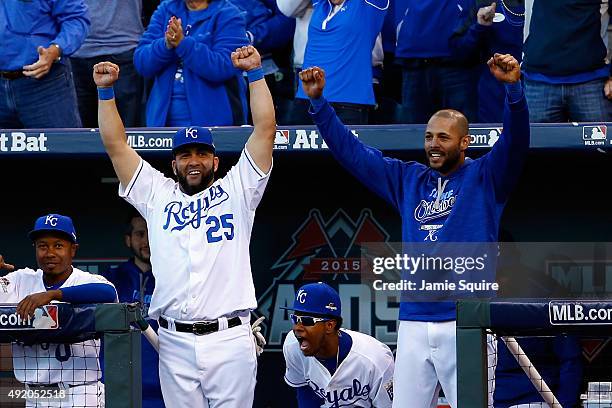 Kendrys Morales of the Kansas City Royals celebrates in the dugout after a challenge from the Royals was reversed to give them the second out in the...