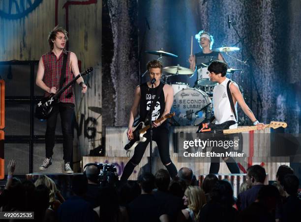 Guitarist Michael Clifford, frontman Luke Hemmings, bassist Calum Hood and drummer Ashton Irwin of 5 Seconds of Summer perform onstage during the...