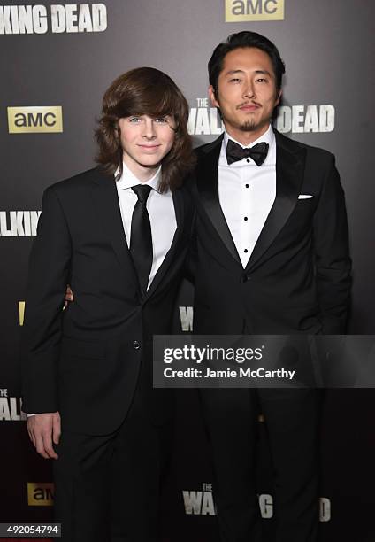 Actors Chandler Riggs and Steven Yeun attend AMC's "The Walking Dead" Season 6 Fan Premiere Event 2015 at Madison Square Garden on October 9, 2015 in...