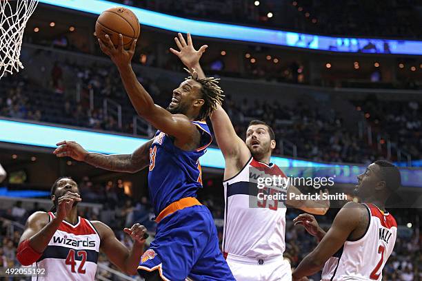 Derrick Williams of the New York Knicks puts up a shot in front of Josh Harrellson of the Washington Wizards during the first half at Verizon Center...