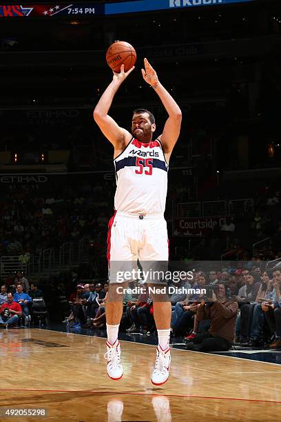 Josh Harrellson of the Washington Wizards shoots against the New York Knicks during a preseason game on October 9, 2015 at Verizon Center in...