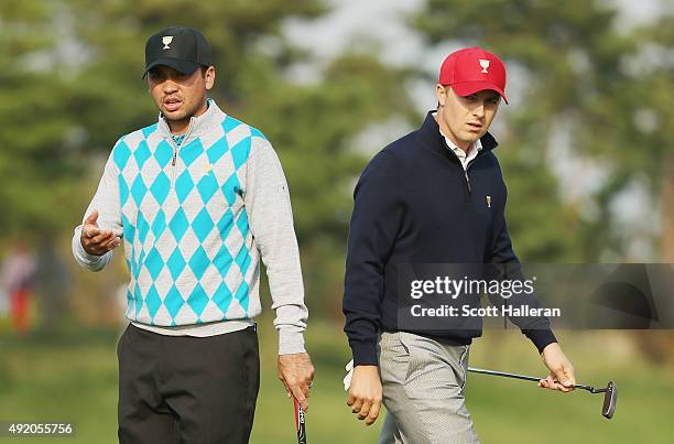 Jason Day of Australia and the International Team waits alongside Jordan Spieth of the United States Team on the second green during the Saturday...