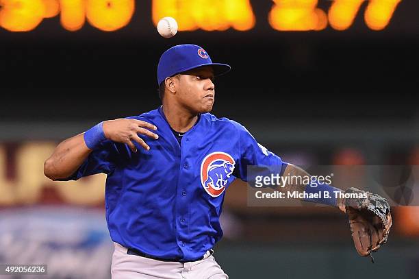 Starlin Castro of the Chicago Cubs bobbles a ball hit by Matt Holliday of the St. Louis Cardinals in the third inning during game one of the National...