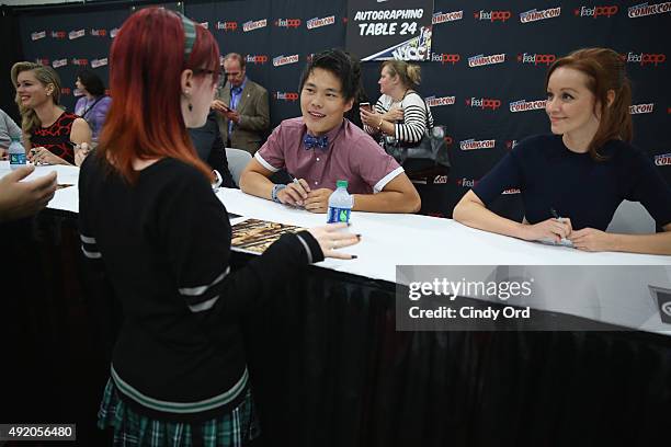 Actors John Kim and Lindy Booth signs memorabilia at the TNT/TBS: The Librarian Season 2 autograph signing. TNT at the New York Comic Con 2015 at the...