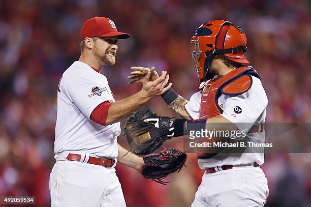 Trevor Rosenthal of the St. Louis Cardinals celebrates with Yadier Molina of the St. Louis Cardinals after defeating the Chicago Cubs in game one of...